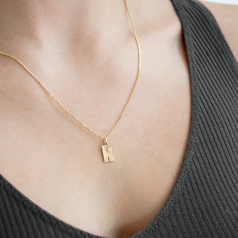 Model Wearing Our 14K Gold “K” Initial Pendant Necklace