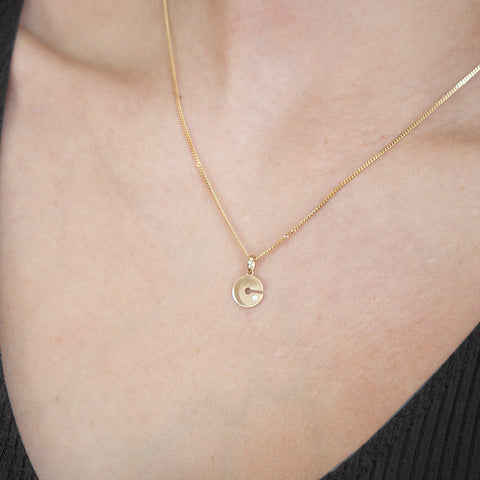 Model wearing our 14K Gold “C” Initial Pendant 